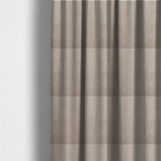 The fabric used to create these made-to-measure curtains is a textured, warm taupe or tan woven upholstery fabric.