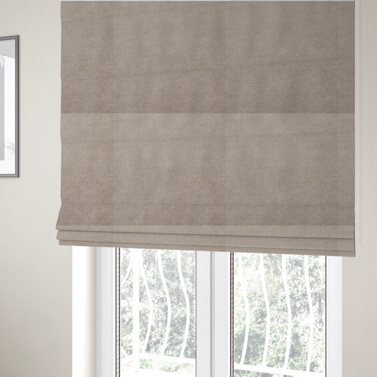 The fabric used to create these Roman blinds is a textured, warm taupe or tan woven upholstery fabric.