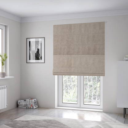 The fabric used to create these Roman blinds is a textured, warm taupe or tan woven upholstery fabric.