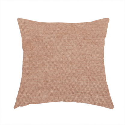 The fabric used to create this handmade cushion is a textured, warm peach or terracotta-coloured woven upholstery fabric.