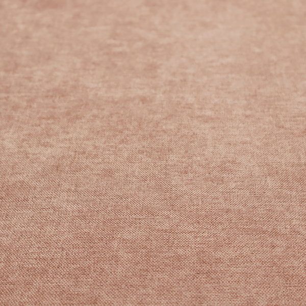 A textured, warm peach or terracotta-coloured woven upholstery fabric.