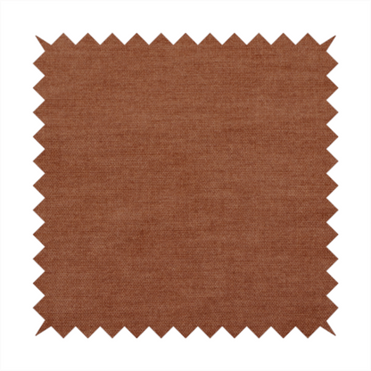 A textured, rich rust or burnt orange woven upholstery fabric.