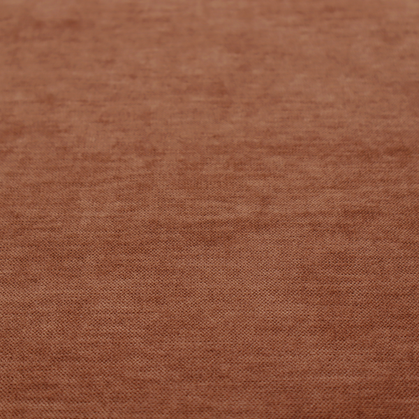 A textured, rich rust or burnt orange woven upholstery fabric.