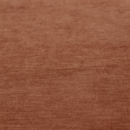 A textured, rich rust or burnt orange woven upholstery fabric.