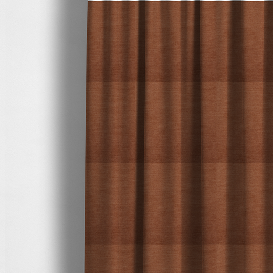 The fabric used to create these made-to-measure curtains is a textured, rich rust or burnt orange woven upholstery fabric.