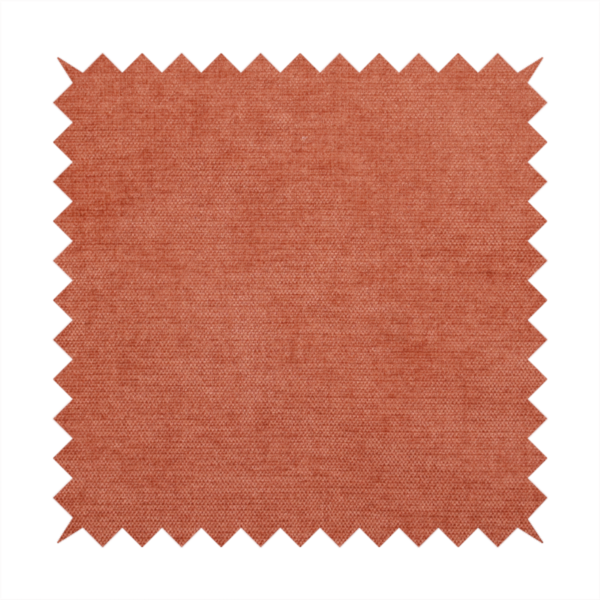 A textured, vibrant burnt orange or coral-coloured woven upholstery fabric.