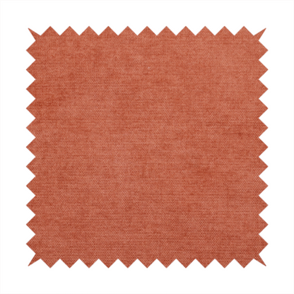 A textured, vibrant burnt orange or coral-coloured woven upholstery fabric.