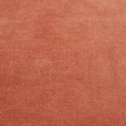 A textured, vibrant burnt orange or coral-coloured woven upholstery fabric.