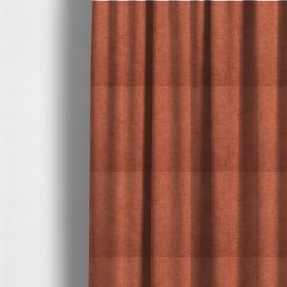 The fabric used to create these made-to-measure curtains is a textured, vibrant burnt orange or coral-coloured woven upholstery fabric.