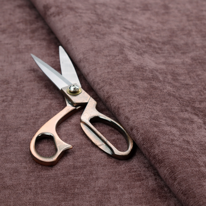 A textured, dusty mauve or muted purple woven upholstery fabric.
