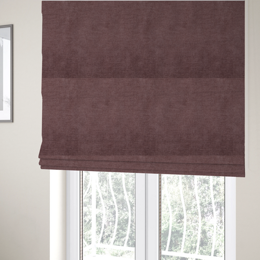 The fabric used to create these Roman blinds is a textured, dusty mauve or muted purple woven upholstery fabric.