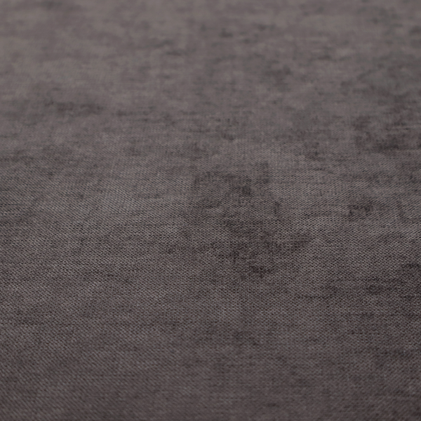 A textured, dark charcoal grey or brown-grey woven upholstery fabric.