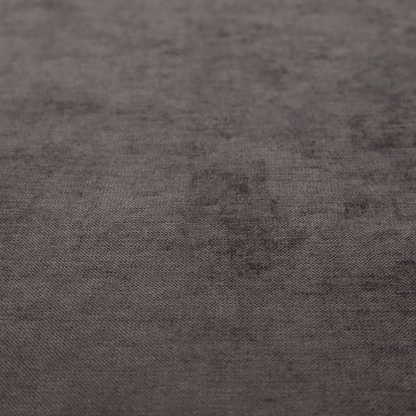 A textured, dark charcoal grey or brown-grey woven upholstery fabric.
