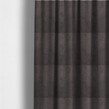 The fabric used to create these made-to-measure curtains is a textured, dark charcoal grey or brown-grey woven upholstery fabric.