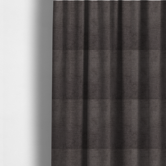 The fabric used to create these made-to-measure curtains is a textured, dark charcoal grey or brown-grey woven upholstery fabric.