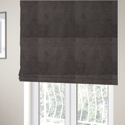The fabric used to create these Roman blinds is a textured, dark charcoal grey or brown-grey woven upholstery fabric.