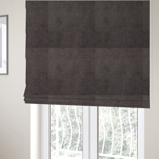 The fabric used to create these Roman blinds is a textured, dark charcoal grey or brown-grey woven upholstery fabric.