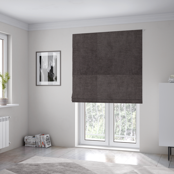The fabric used to create these Roman blinds is a textured, dark charcoal grey or brown-grey woven upholstery fabric.