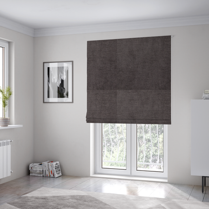 The fabric used to create these Roman blinds is a textured, dark charcoal grey or brown-grey woven upholstery fabric.