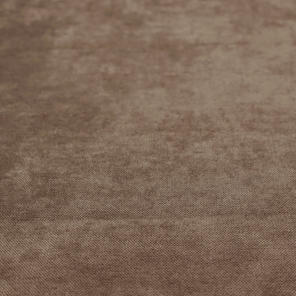 A textured, medium brown or bronze woven upholstery fabric.