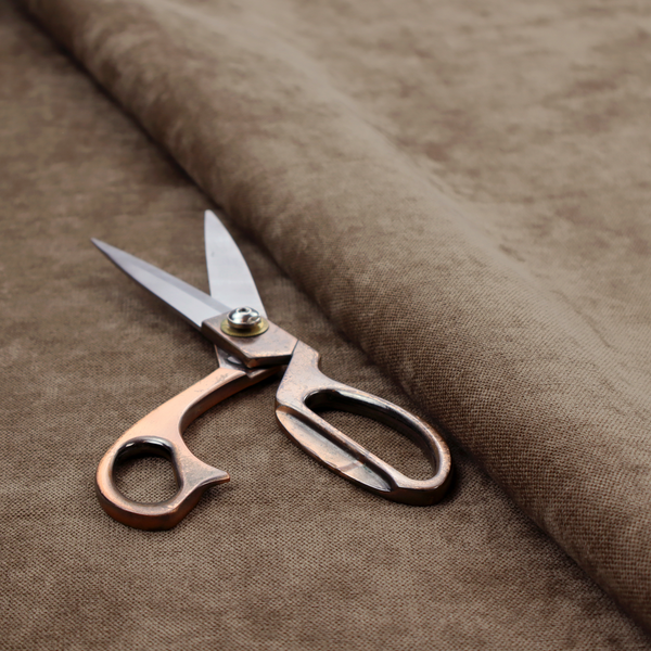A textured, medium brown or bronze woven upholstery fabric.