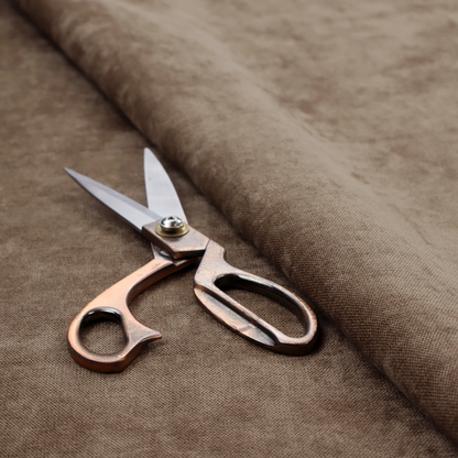 A textured, medium brown or bronze woven upholstery fabric.