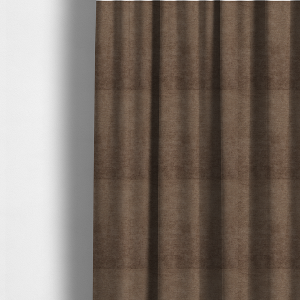 The fabric used to create these made-to-measure curtains is a textured, medium brown or bronze woven upholstery fabric.