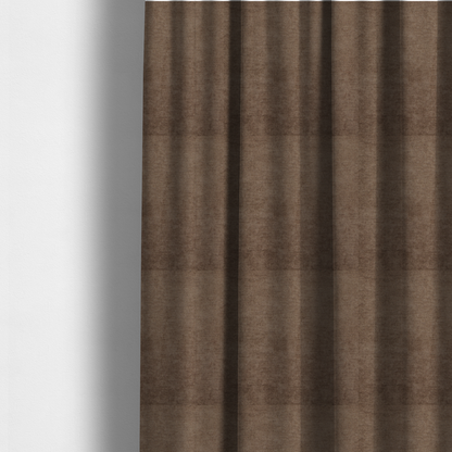 The fabric used to create these made-to-measure curtains is a textured, medium brown or bronze woven upholstery fabric.