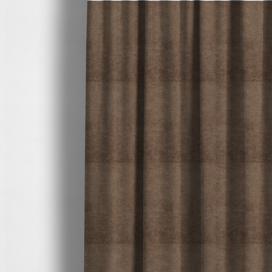 The fabric used to create these made-to-measure curtains is a textured, medium brown or bronze woven upholstery fabric.