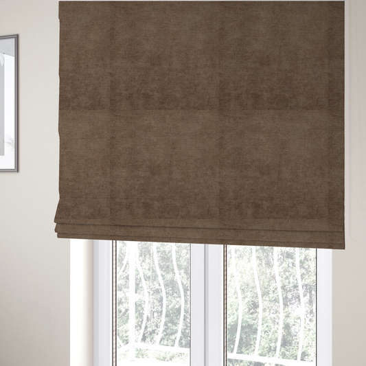 The fabric used to create these Roman blinds is a textured, medium brown or bronze woven upholstery fabric.