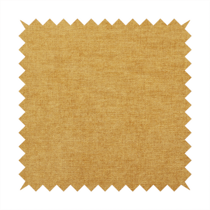 A textured, golden yellow or mustard woven upholstery fabric.