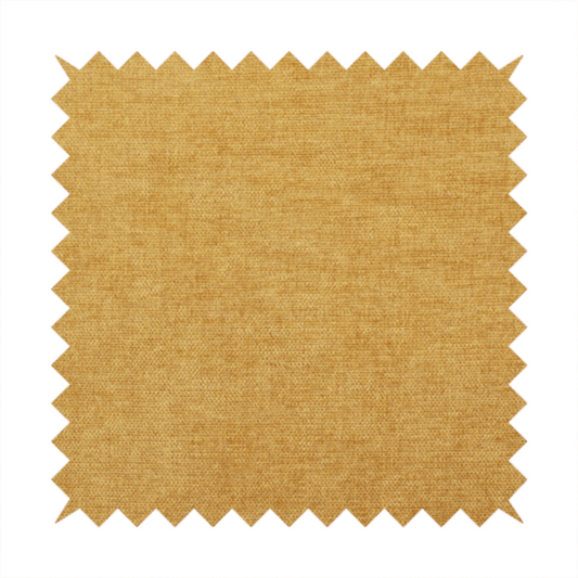 A textured, golden yellow or mustard woven upholstery fabric.