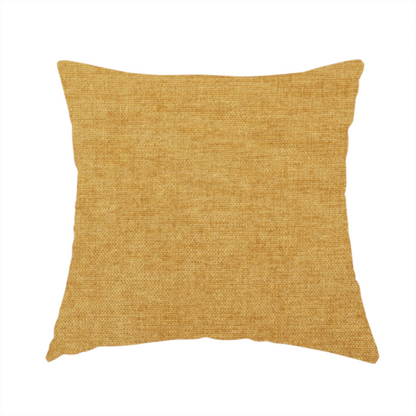 The fabric used to create this handmade cushion is a textured, golden yellow or mustard woven upholstery fabric.