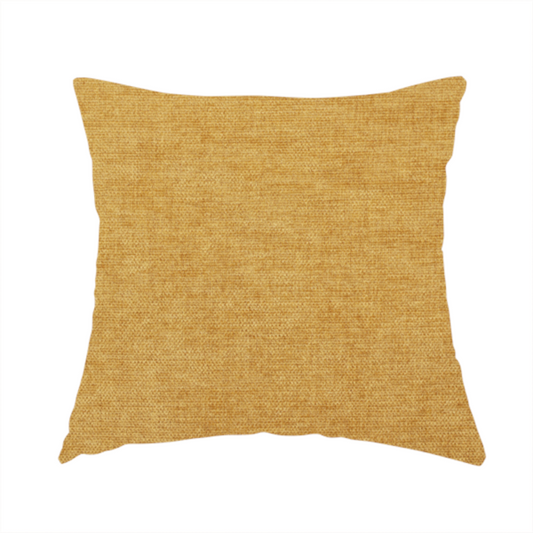 The fabric used to create this handmade cushion is a textured, golden yellow or mustard woven upholstery fabric.