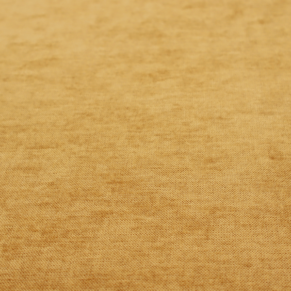 A textured, golden yellow or mustard woven upholstery fabric.