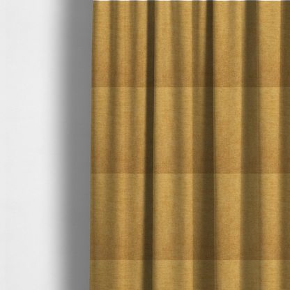 The fabric used to create these made-to-measure curtains is a  textured, golden yellow or mustard woven upholstery fabric.