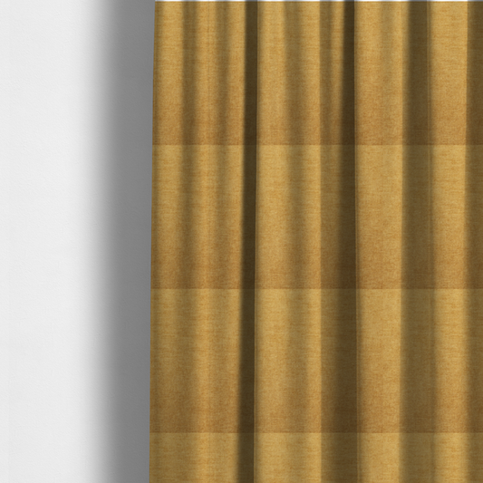 The fabric used to create these made-to-measure curtains is a  textured, golden yellow or mustard woven upholstery fabric.