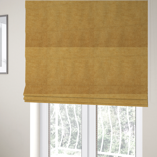 The fabric used to create these Roman blinds is a textured, golden yellow or mustard woven upholstery fabric.