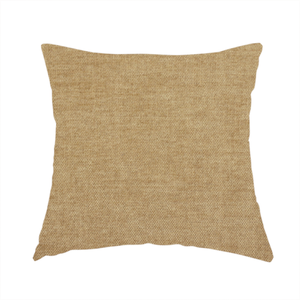 The fabric used to create this handmade cushion is a textured, light brown or camel-coloured woven upholstery fabric.