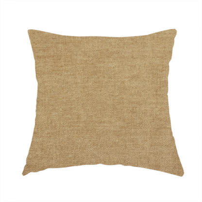The fabric used to create this handmade cushion is a textured, light brown or camel-coloured woven upholstery fabric.