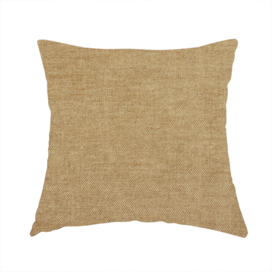 The fabric used to create this handmade cushion is a textured, light brown or camel-coloured woven upholstery fabric.