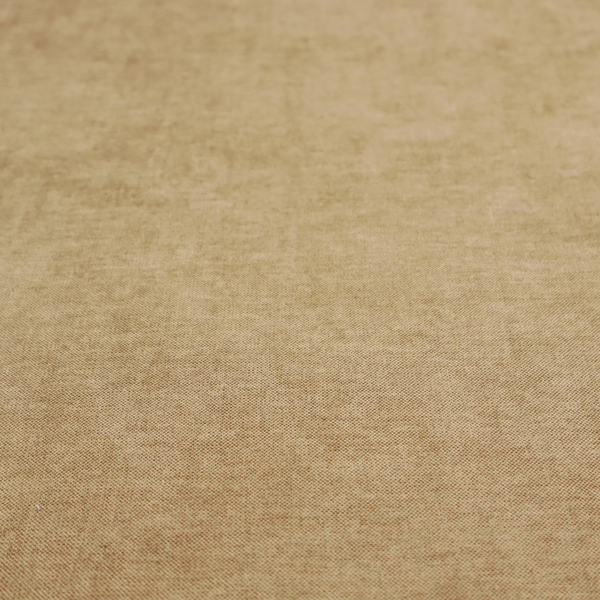 A textured, light brown or camel-coloured woven upholstery fabric.