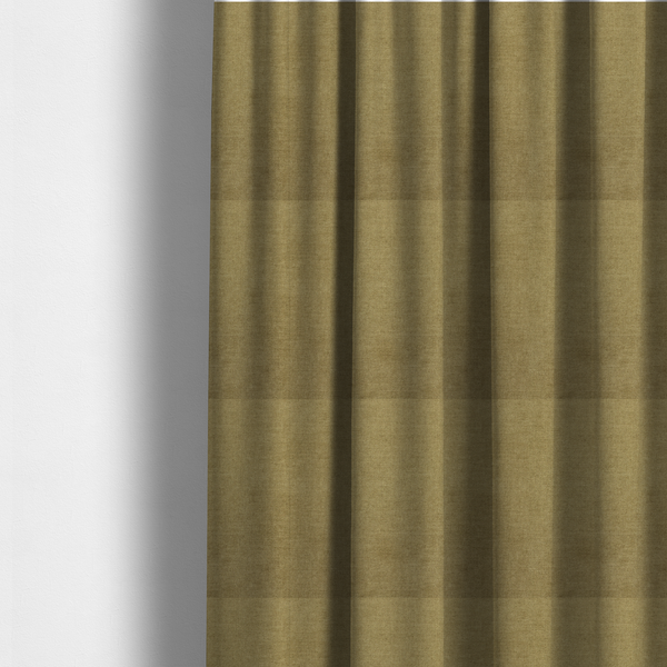 The fabric used to create these made-to-measure curtains is a textured, olive green or muted bronze woven upholstery fabric.