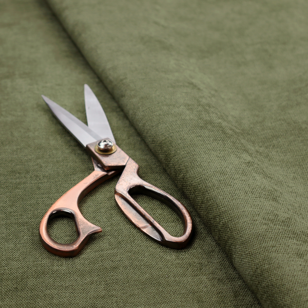 A textured, deep sage green or moss green woven upholstery fabric.