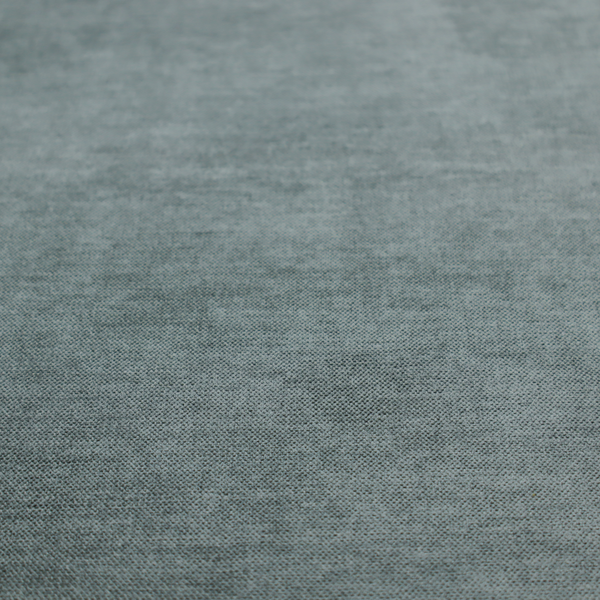 A textured, grey-blue or muted teal woven upholstery fabric.