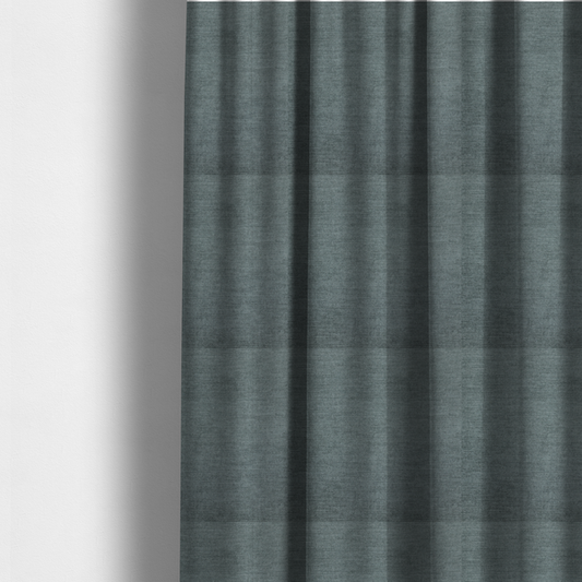 The fabric used to create these made-to-measure curtains is a textured, grey-blue or muted teal woven upholstery fabric.