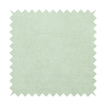A textured, light mint green or pale sage green woven upholstery fabric.