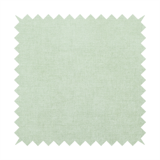 A textured, light mint green or pale sage green woven upholstery fabric.