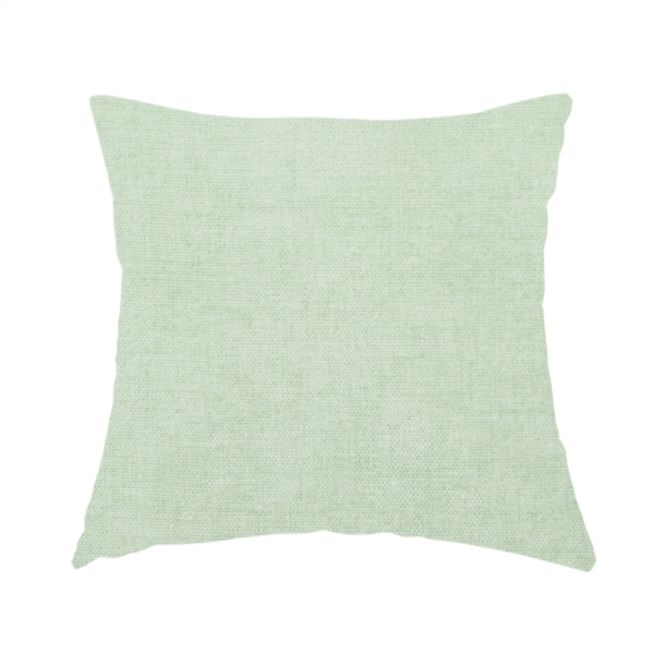 The fabric used to create this handmade cushion is a textured, light mint green or pale sage green woven upholstery fabric.