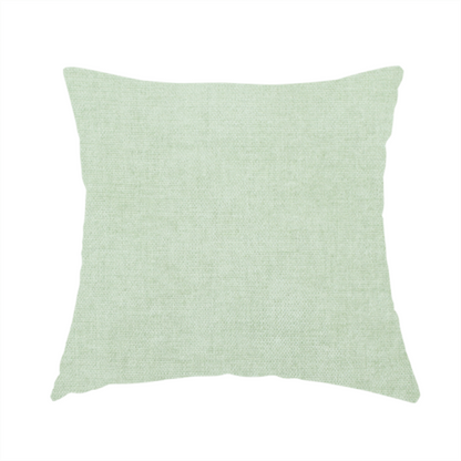 The fabric used to create this handmade cushion is a textured, light mint green or pale sage green woven upholstery fabric.